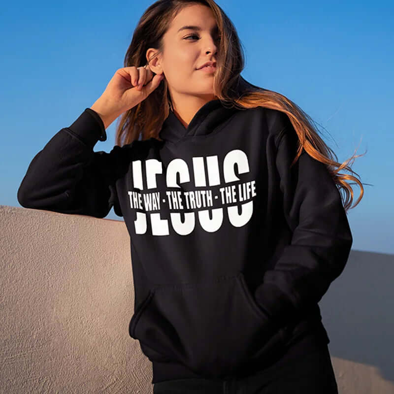 Woman wearing black Christian sweatshirt with "Jesus the Way the Truth the Life" print, perfect for autumn inspiration and warmth.