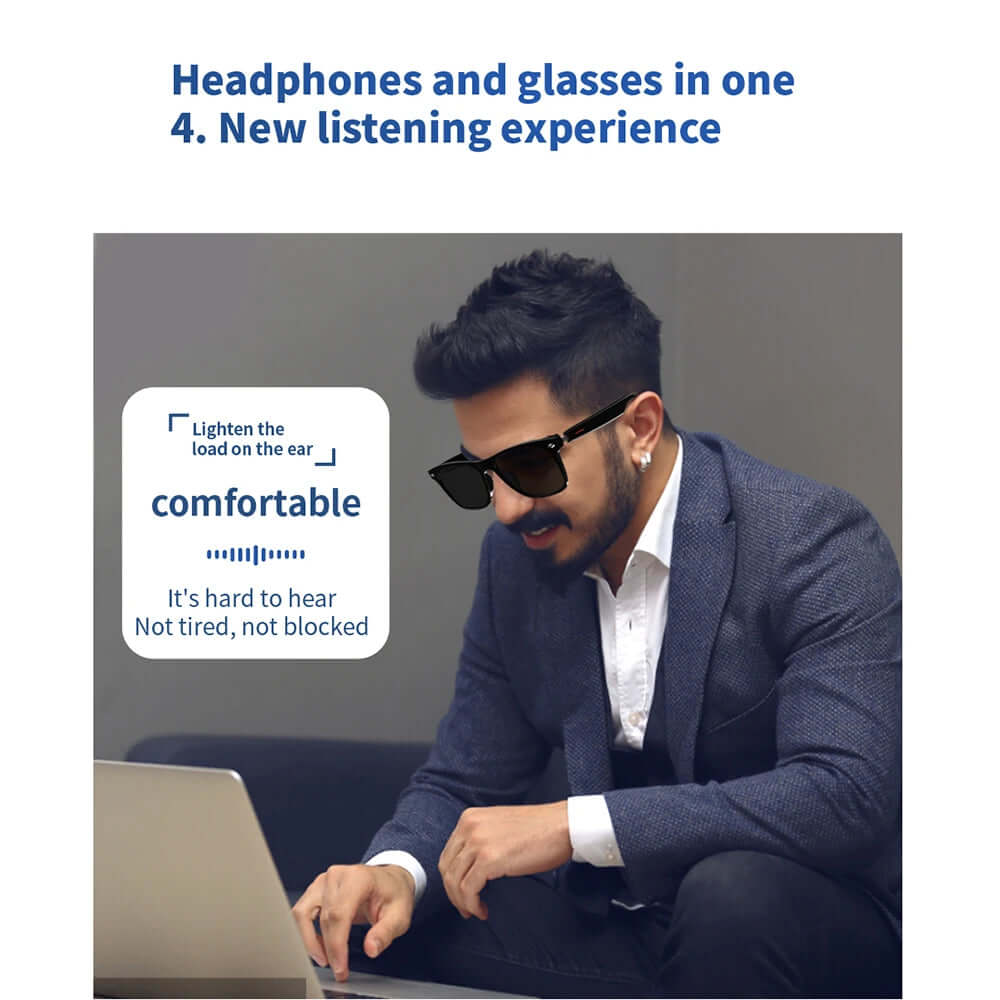 Man using smart glasses with built-in headphones for a new listening experience while working on a laptop.