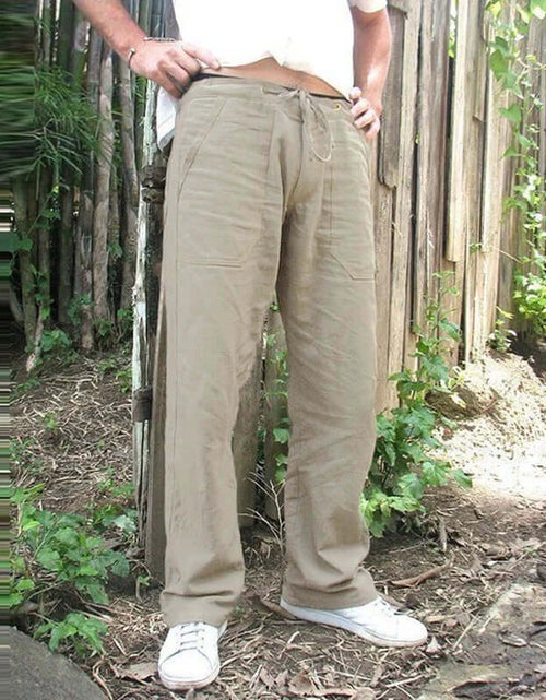 Load image into Gallery viewer, Men&#39;s cotton linen trousers in khaki with elastic waist, shown outdoors. Fashionable, casual style for summer in multiple sizes.
