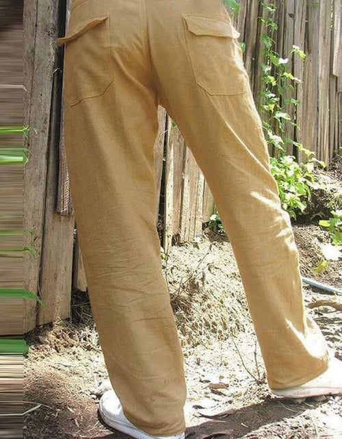 Load image into Gallery viewer, Khaki cotton-linen men&#39;s trousers with pockets, perfect for summer casual wear, shown outdoors for fashion styling.
